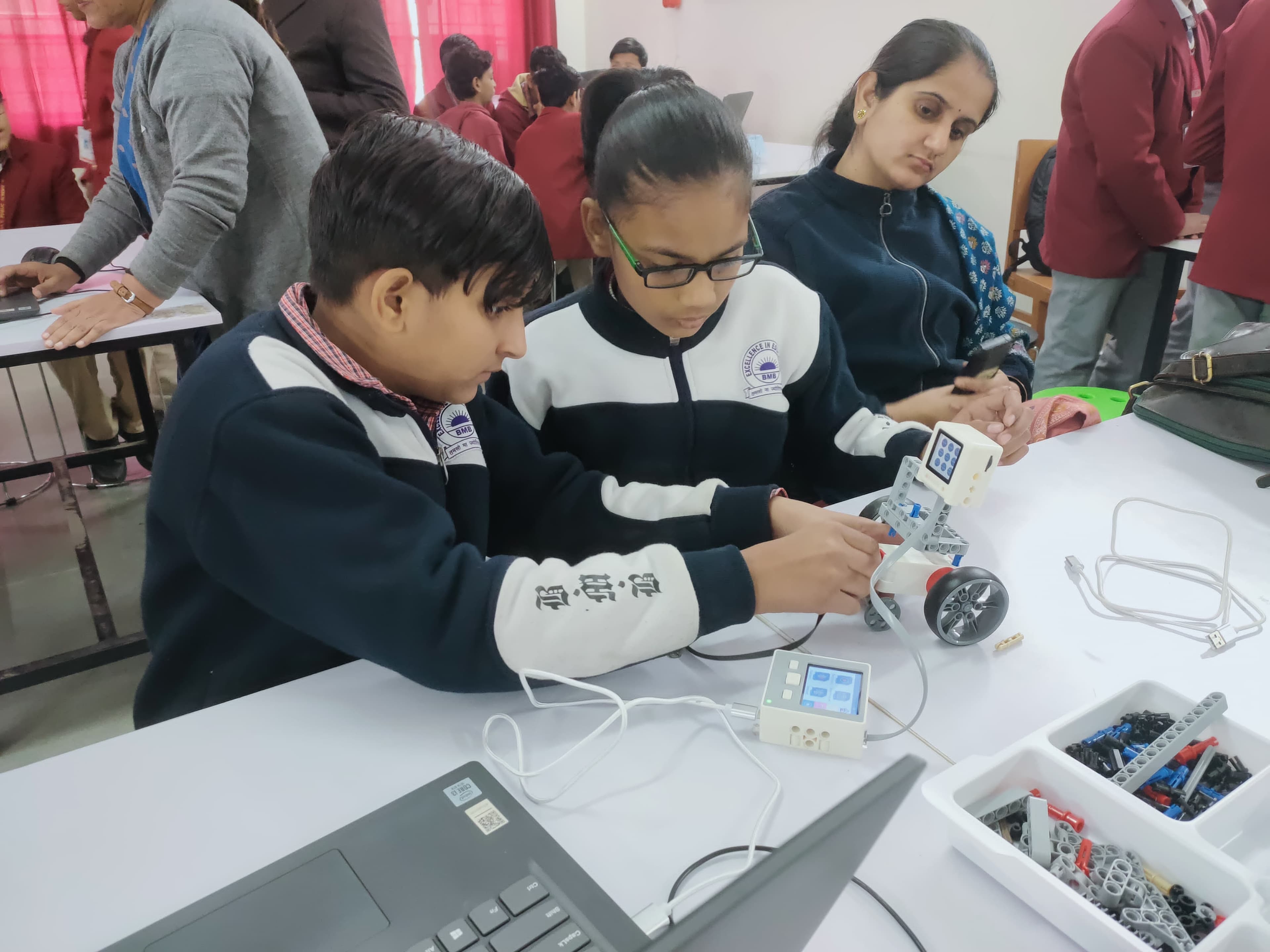 Students collaborating around lab hardware and digital tools