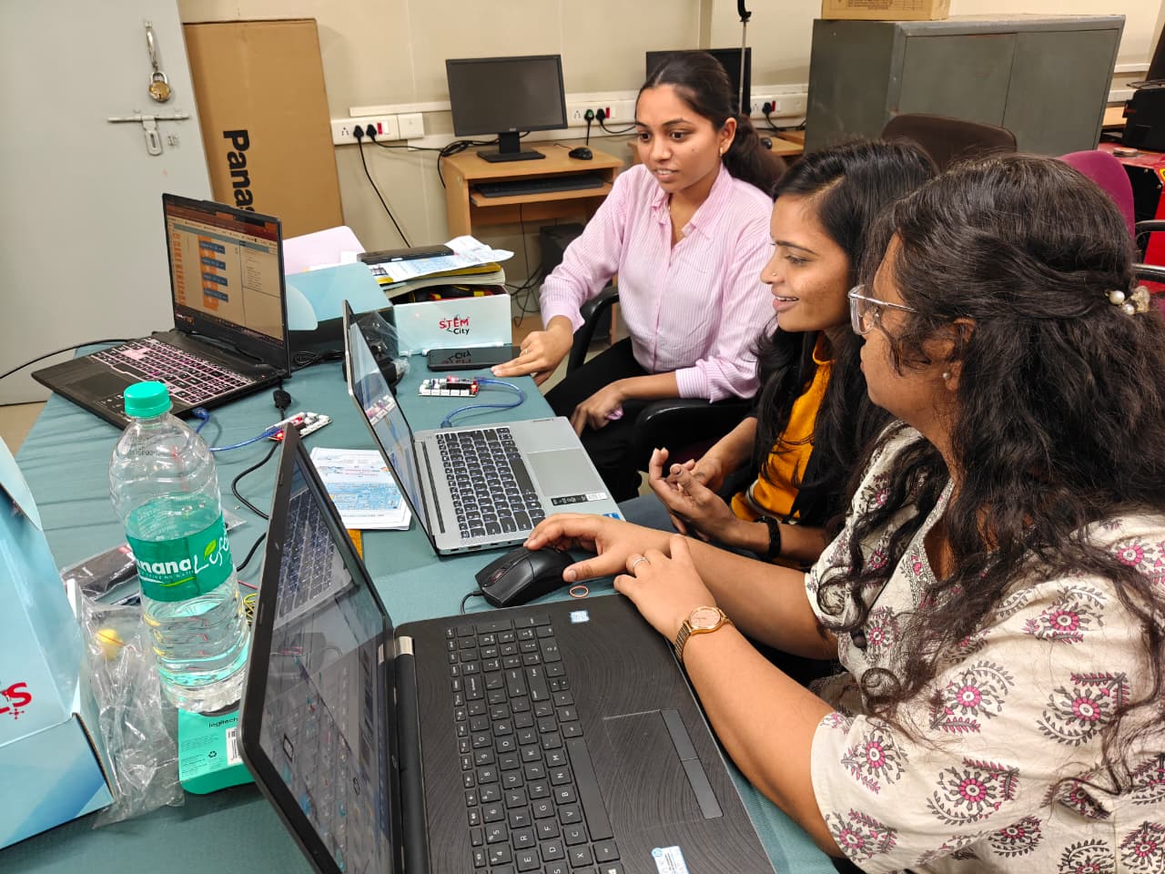 Teachers and learners engaged in a collaborative lab activity